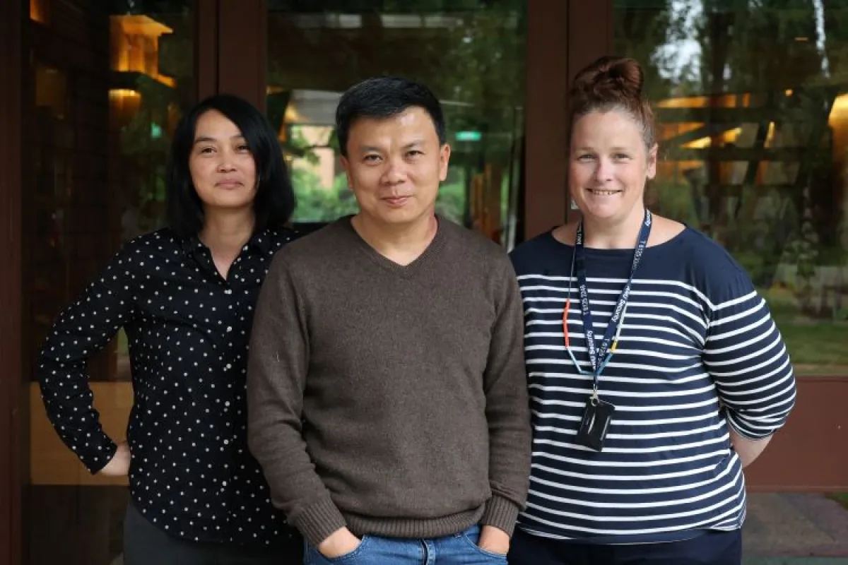 A trio of Education Technologists stand together. The image is from the waist up.