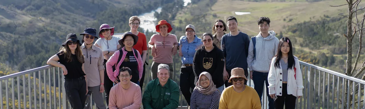 A group of students at a lookout overlooking a river.