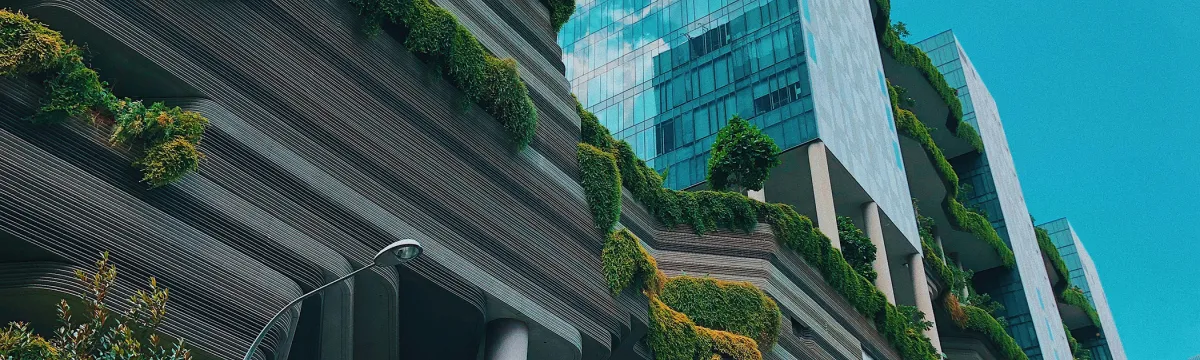A photo of a green building taken from below.