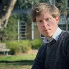 Ben sits in a garden at ANU.