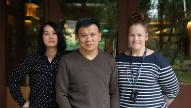 Three staff members pose for a photo.